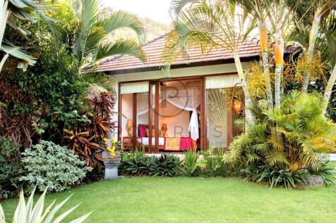 A cozy bungalow surrounded by lush tropical plants