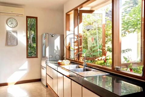 Bright kitchen with large windows, a sink with a r