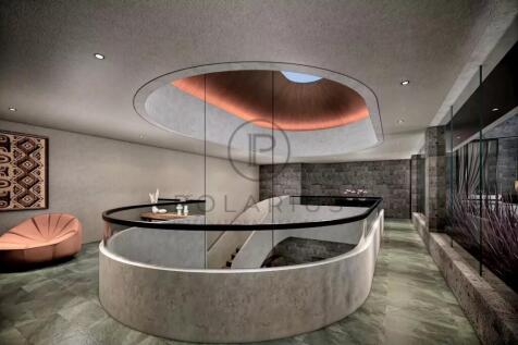 A modern interior with a curved staircase, glass r