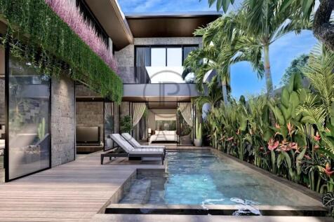 A luscious tropical pool area with large deck over