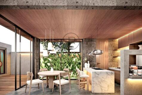 A modern kitchen and dining area featuring a woode