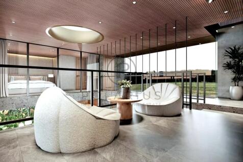 A modern, stylish interior features plush chairs, 