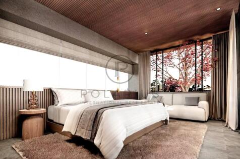 A modern bedroom with a large bed, wooden accents,