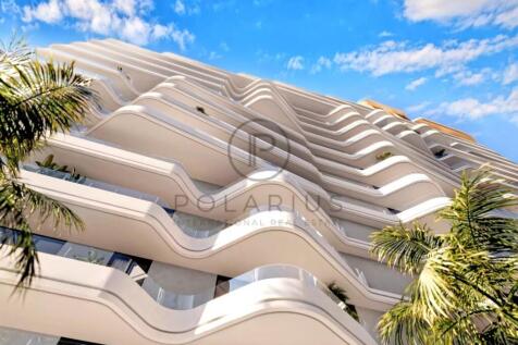 Modern building with wavy balconies, surrounded by