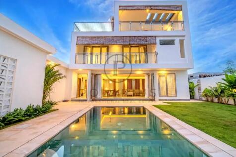 Modern multi-story house with large windows, a bal