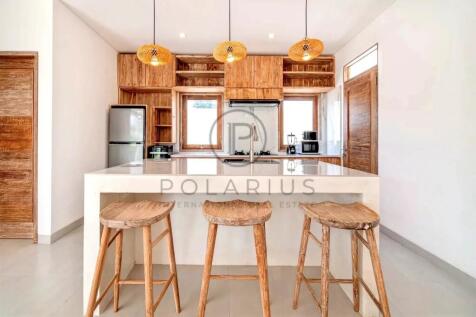 Modern kitchen with a large island, wooden barstoo