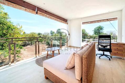 Bright room with large windows, offering a view of