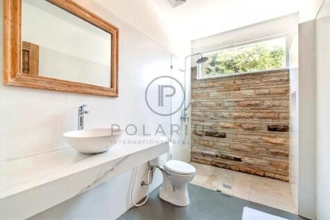 A modern bathroom with a vessel sink on a marble c