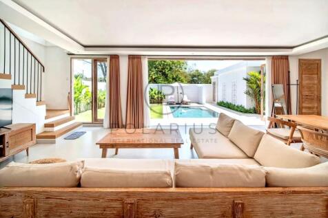 A bright, modern living room with wooden furniture
