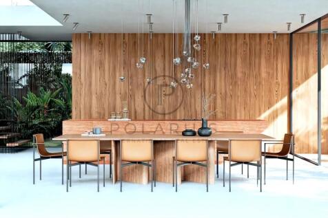 Modern dining room with a wooden table, tan chairs