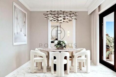 A modern dining room features a round table with w