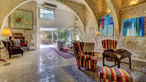 A stylish room with stone arches features colorful