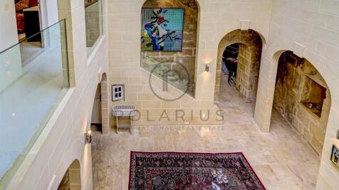 The image shows an elegant interior with stone wal