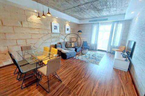 A modern living and dining area with wooden floors