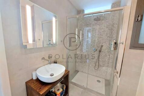 Modern bathroom featuring a glass-enclosed shower 