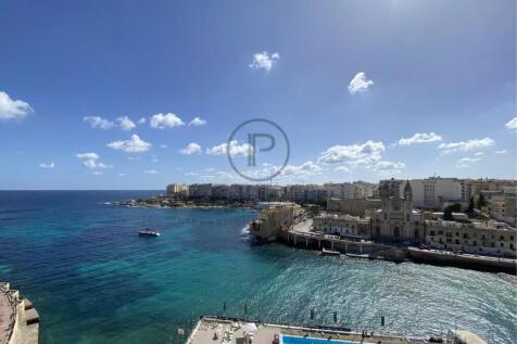 A coastal cityscape with vibrant blue waters, a sw