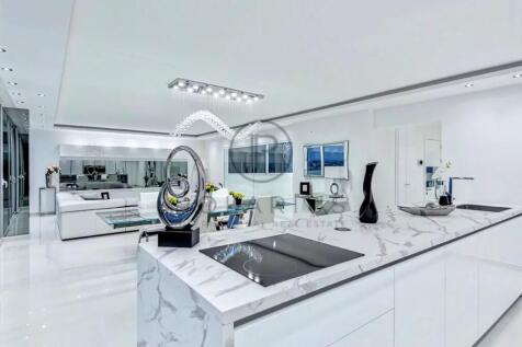 A modern, sleek kitchen and living space with a mi