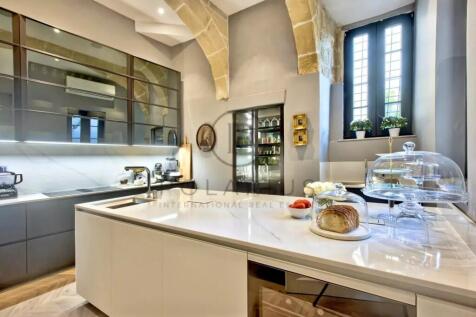 Modern kitchen with sleek cabinetry, a white marbl