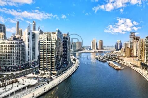 A modern cityscape with tall, sleek buildings lini