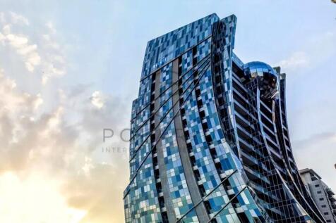 A modern skyscraper with a reflective, angular des