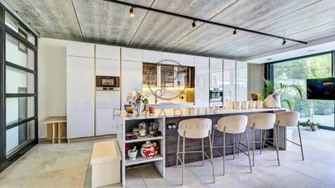 A modern kitchen with sleek white cabinets and a l
