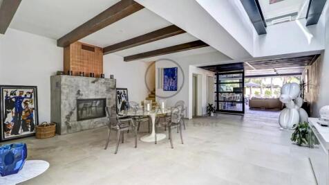 A modern, spacious living area with a dining table