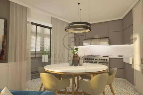 Modern kitchen with a round dining table, plush ch