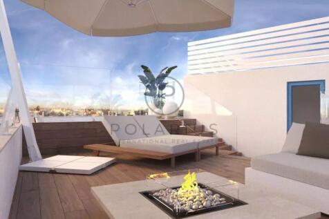 Rooftop terrace with modern lounge chairs, a fire