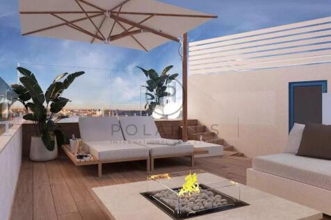 A modern rooftop terrace featuring comfortable sea