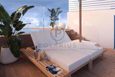 A luxurious outdoor terrace with two sun loungers,