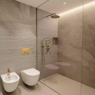 Modern bathroom with beige tiles, featuring a wall