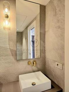 A modern bathroom with textured walls, a rectangul