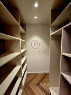 A narrow corridor with wooden shelves on both side