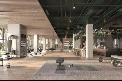 A spacious, modern gym with various exercise equip