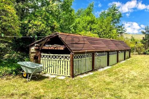 A rustic wooden structure with a sloped roof stand