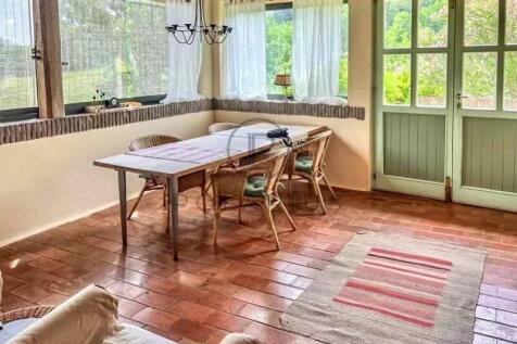 A cozy sunlit room with a wooden table and wicker
