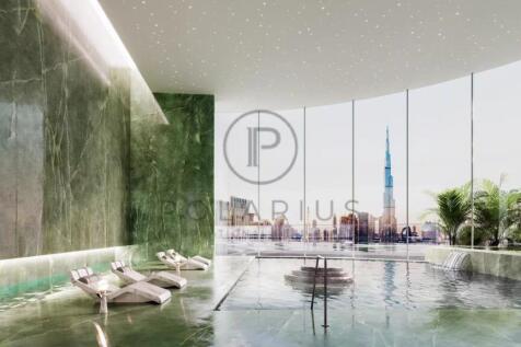 Luxurious indoor pool area with green marble walls