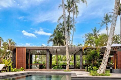 Modern tropical villa with large windows, surround