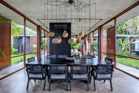 A contemporary dining area features a long black t