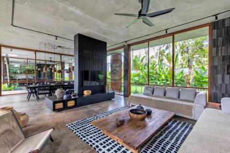 A modern living room features large glass windows 