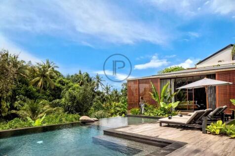 A modern house with a wooden exterior sits next to