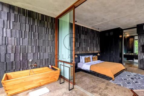 Modern bedroom with a wooden bathtub, stone-textur