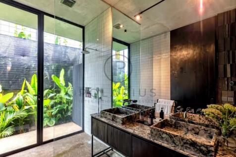Modern bathroom with a glass shower and double sin