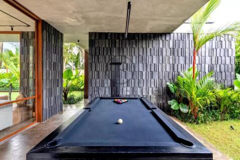 A modern outdoor area features a sleek black pool 