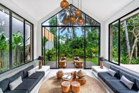 A modern living space features large glass windows