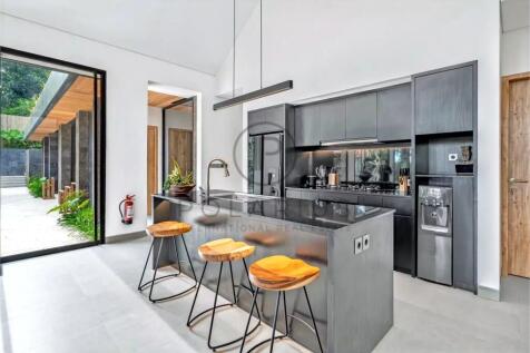 Modern kitchen with a sleek black design, featurin