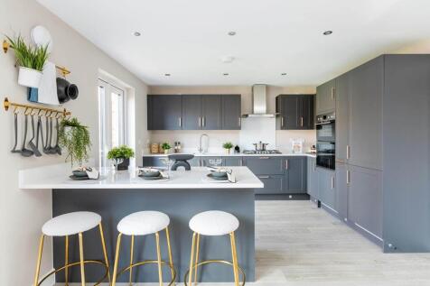A breakfast bar in the kitchen offer space to grab a quick bite or catch up with the family