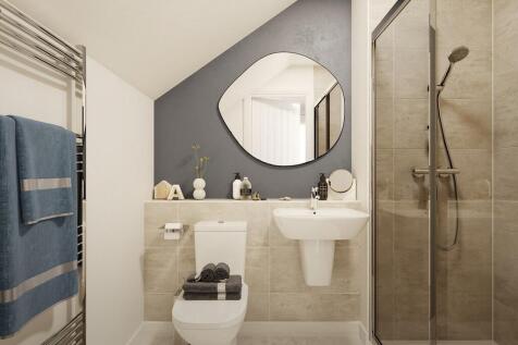 The top floor bedroom features en suite shower room