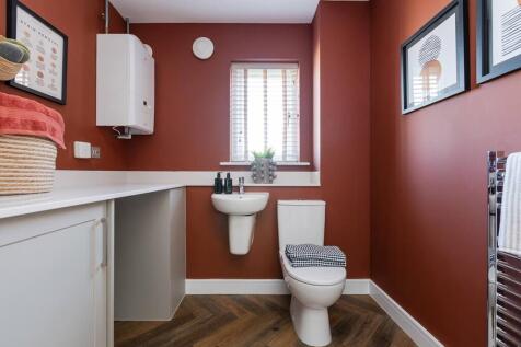 The guest cloakroom features a handy utility area