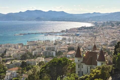 A scenic view of a coastal city with a castle-like